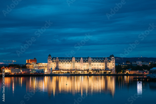 Oslo, Norway. Night View Embankment And Residential Multi-storey House On Langkaia Street In City Center In Oslo, Norway. Summer Evening. Residential Area Reflected In Sea Waters © Grigory Bruev
