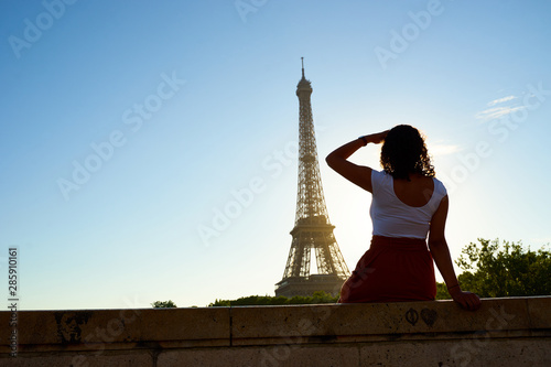 Mixed Race Model with curly hair posing in red skirt and white shirt before Eiffel Tower in Paris © marako85