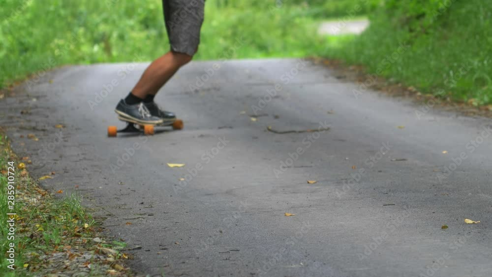 Man Riding Longboard Skateboard on Asphalt Road Slow Motion Man Riding Longboard Skateboard on Asphalt Road Slow Motion