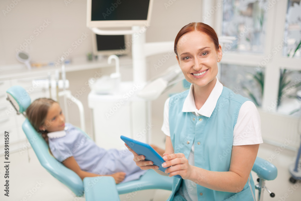 Fototapeta premium Beaming beautiful child dentist smiling before examination