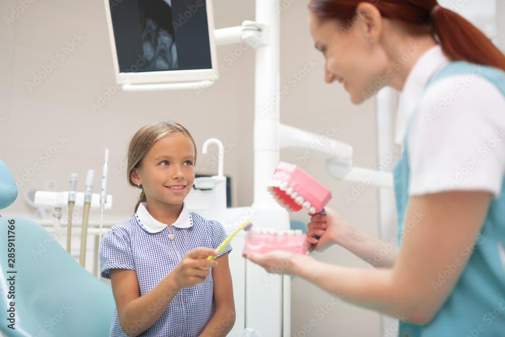 Beautiful girl smiling while visiting cool dentist Beautiful girl smiling while visiting cool dentist