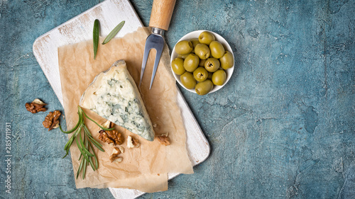 Soft blue cheese with rosemary, nuts and green olives