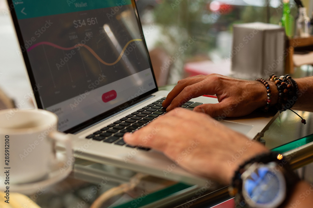 Man calculating the expenses on his laptop.