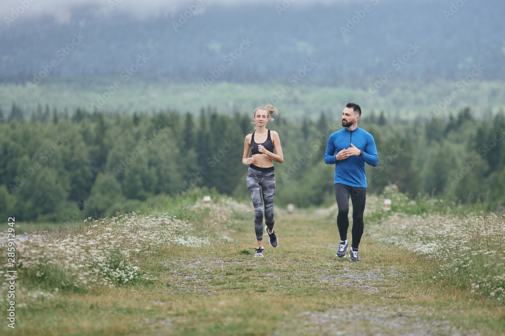 Couple jogging outdoor on gloomy day