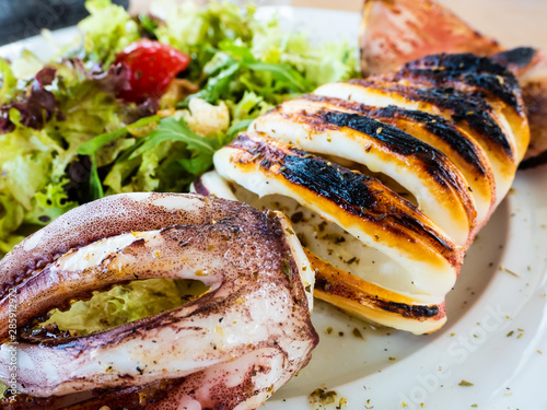 Sticker grilled squid in a Greek summer dish with salad, for a very tasty meal