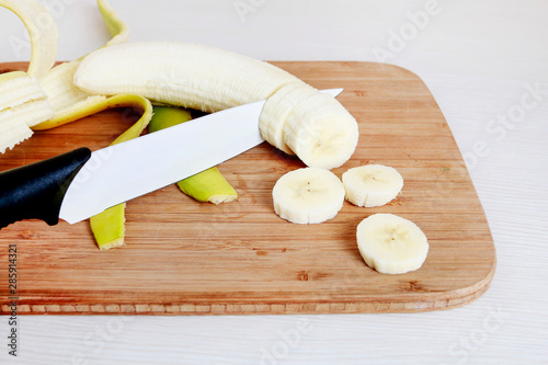 Sliced banana on wooden board.