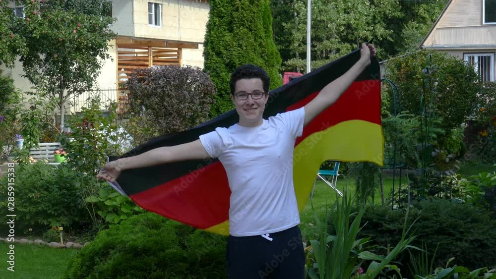 Young people waving a flag outdoors