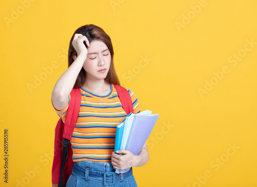  stressed female young student holding books