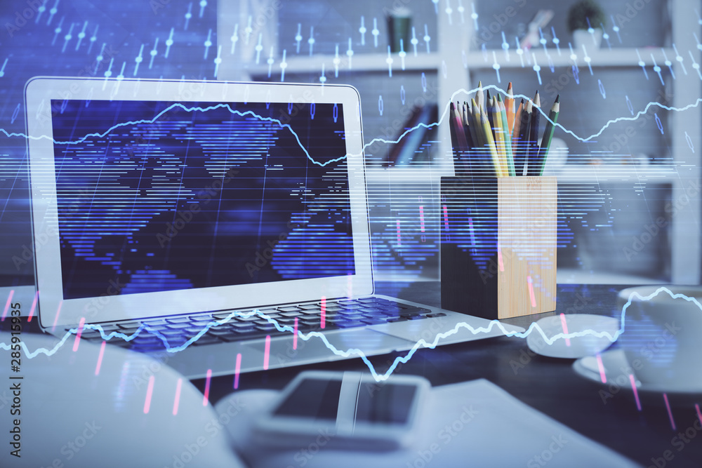 Stock market chart hologram drawn on personal computer background. Multi exposure. Concept of investment. Stock market chart hologram drawn on personal computer background. Multi exposure. Concept of investment.
