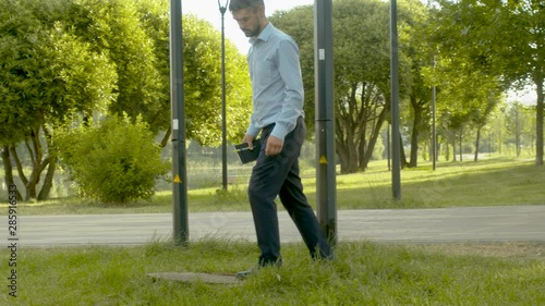 Inspector checking the manhole cover and making notes in the diary