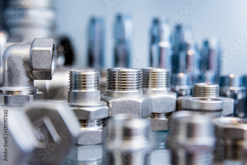 Hosepipe fittings on the table. Plumbing pipeline spare parts. photo