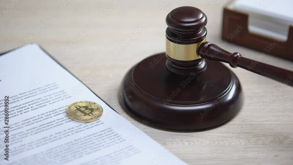 Bitcoin on document, gavel striking on sound block, digital currency regulations Bitcoin on document, gavel striking on sound block, digital currency regulations