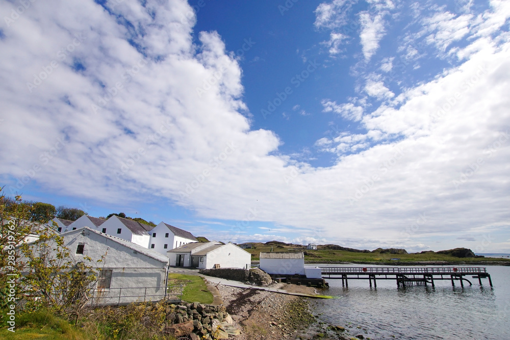 The pier and the building of a whisky distillery on the Isle of Islay