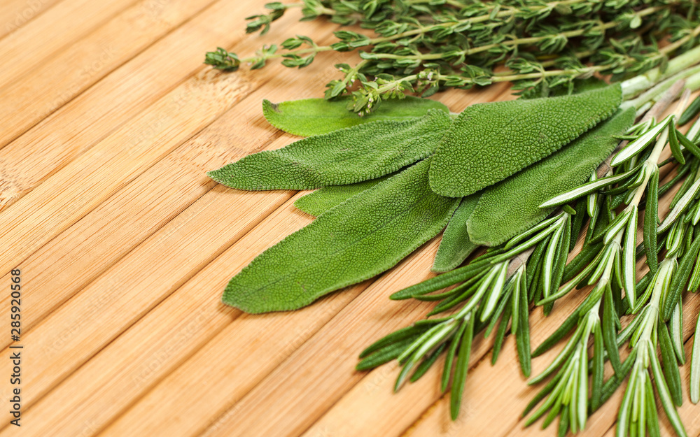 Collection of fresh herbs for cooking isolated on wooden background. Bunch of herbs Collection of fresh herbs for cooking isolated on wooden background. Bunch of herbs
