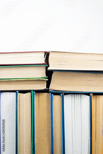 Top view stack of many books on white background with copy space. School, education, reading or literature concept