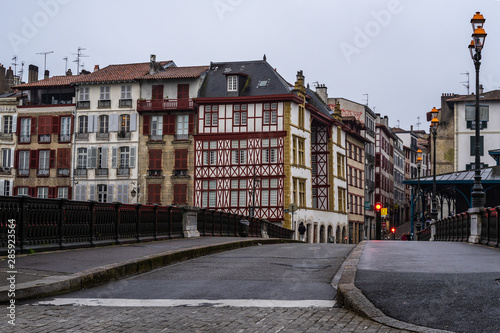Bridge over Nive river in Bayonne with typical half timbered houses in the old town, France