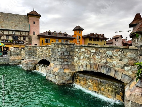 Old fashion Bridge with small waterfalls over the old fashion town river- Riverland in Dubai