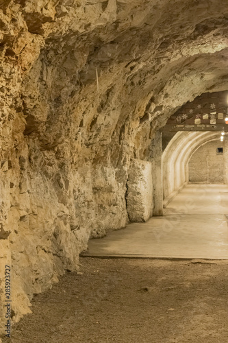 Part of the small underground tunnel with the stone wall - Image