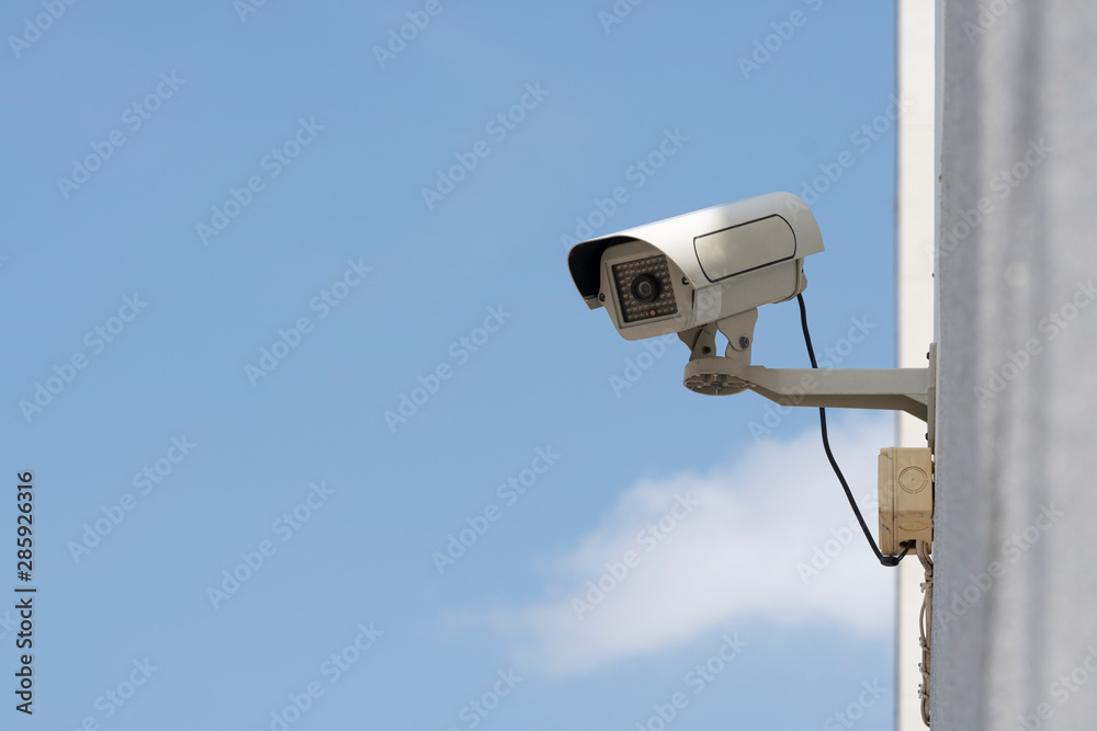 outdoor security cameras in garden , on blue sky background