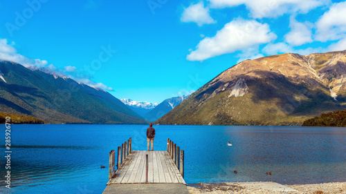 Man on the pier, Rotoiti River, Nelson Lakes National Park, New Zealand. photo
