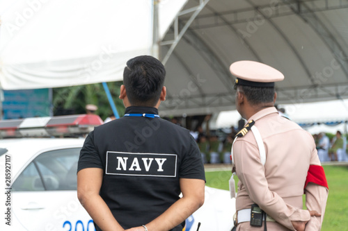 Men in the form of Thai Navy security personnel stand ready