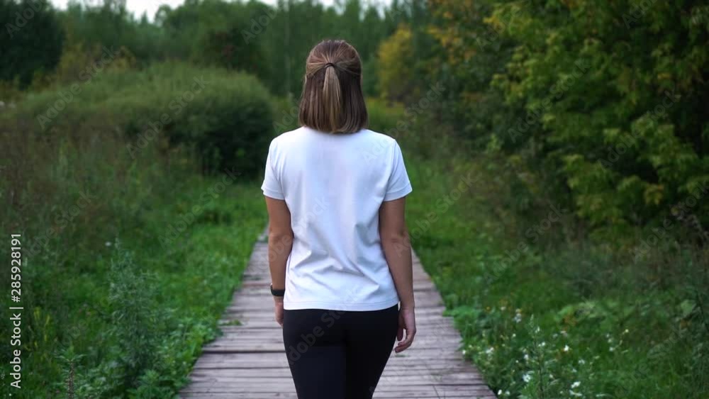 Slow motion young fit girl walking away then turns around and calls you with a gesture. Follow me Slow motion young fit girl walking away then turns around and calls you with a gesture. Follow me