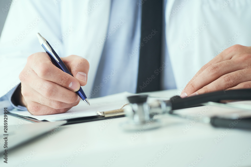 Mid section of male doctor writing write prescription to patient at worktable. Panacea and life save, prescribing treatment. Mid section of male doctor writing write prescription to patient at worktable. Panacea and life save, prescribing treatment.
