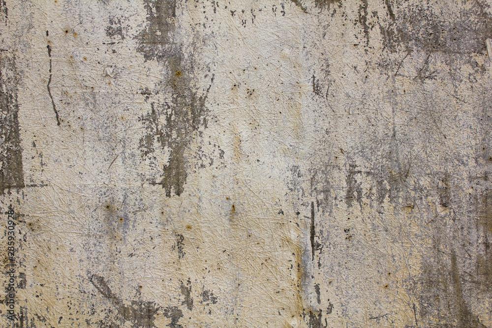 old peeled gray wall with fibrous white spots and scratches. rough surface texture