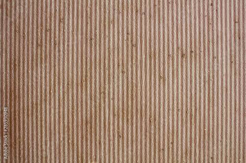 old rusty gray brown wavy metal wall with peeling paint. vertical lines. rough surface texture