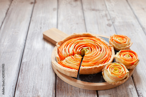 Homemade vegetable tart with cabbage and carrot decorated with basil on old wooden table photo