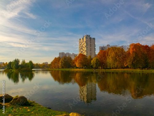 Autumn time, autumn in the city, urban autumn landscape with a pond, people walking and other fun