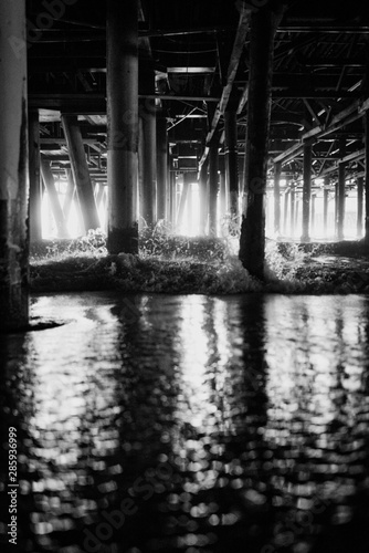 Black and white iew of the pylons of Santa Monica pier in Los Angeles USA