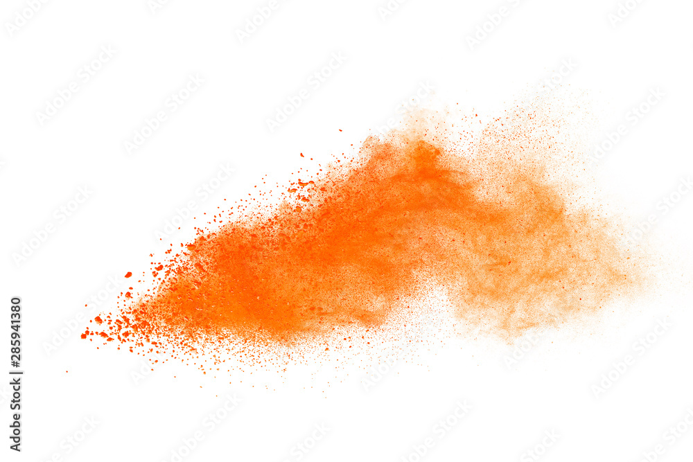 Abstract orange powder explosion. Closeup of orange dust particle splash isolated on white background