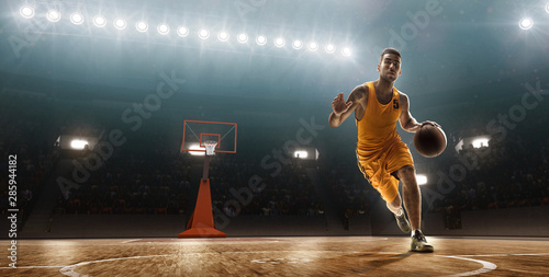 Basketball player runs with the ball on basketball court © TandemBranding