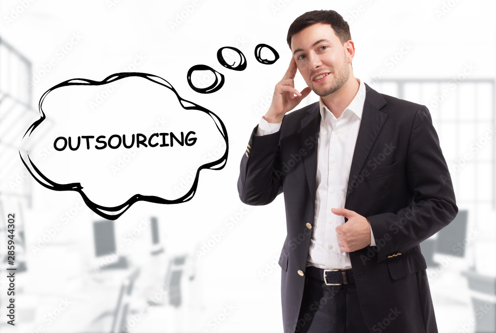 Business, technology, internet and network concept. The young businessman comes up with the keyword: Outsourcing Business, technology, internet and network concept. The young businessman comes up with the keyword: Outsourcing