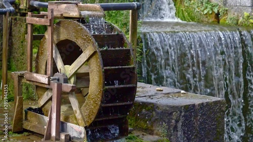 Still slow motion shot a waterwheel and a manmade waterfall. photo