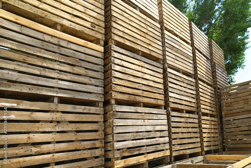 Pile of empty wooden crates outdoors on sunny day Pile of empty wooden crates outdoors on sunny day