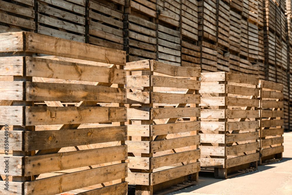 Old empty wooden crates outdoors on sunny day