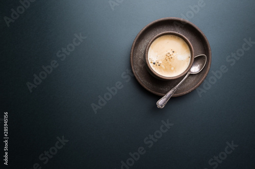 Cup of coffee on a black background. top view with copy space. morning concept.