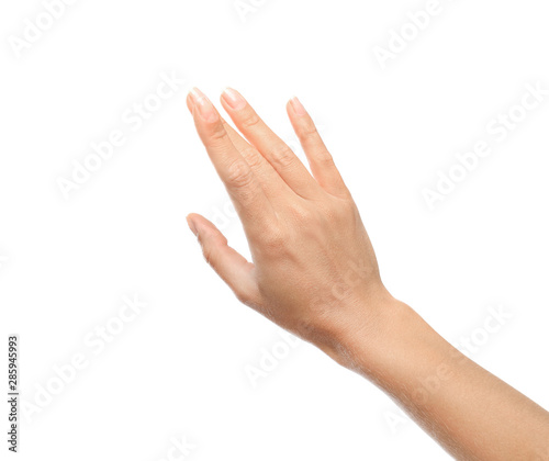 Young woman held out hand on white background, closeup photo