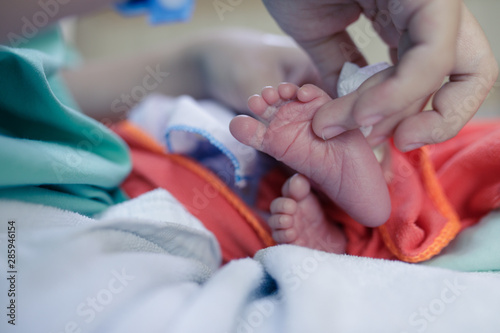 feet of newborn baby,Mother's hand touched the baby's feet,baby in the hospital,Happy Family concept