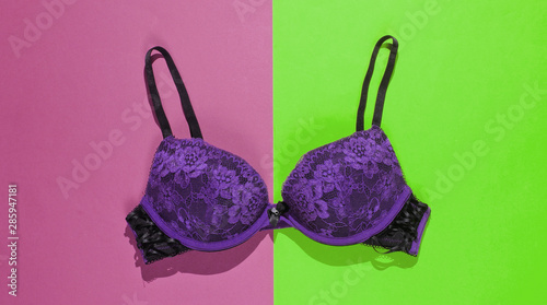 Sexy female bra on purple green background. Beautiful underwear. Top view