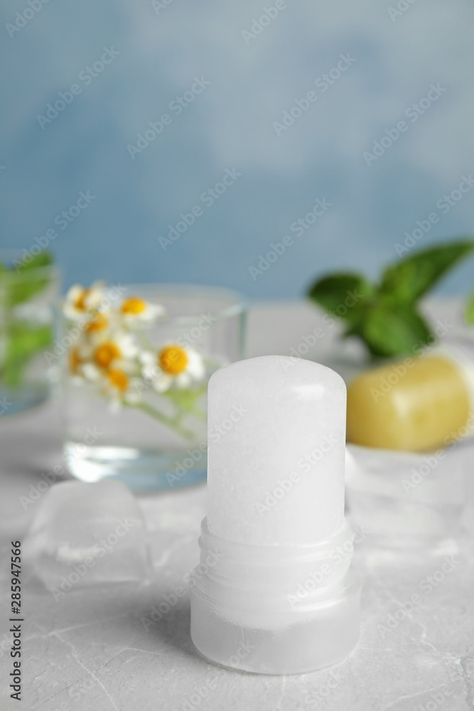 Natural crystal alum deodorant on light grey marble background