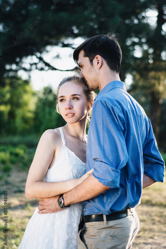 Happy loving couple embracing outdoors at summertime. Couple love. Man and woman nature. Happy loving couple embracing outdoors at summertime. Couple love. Man and woman nature.