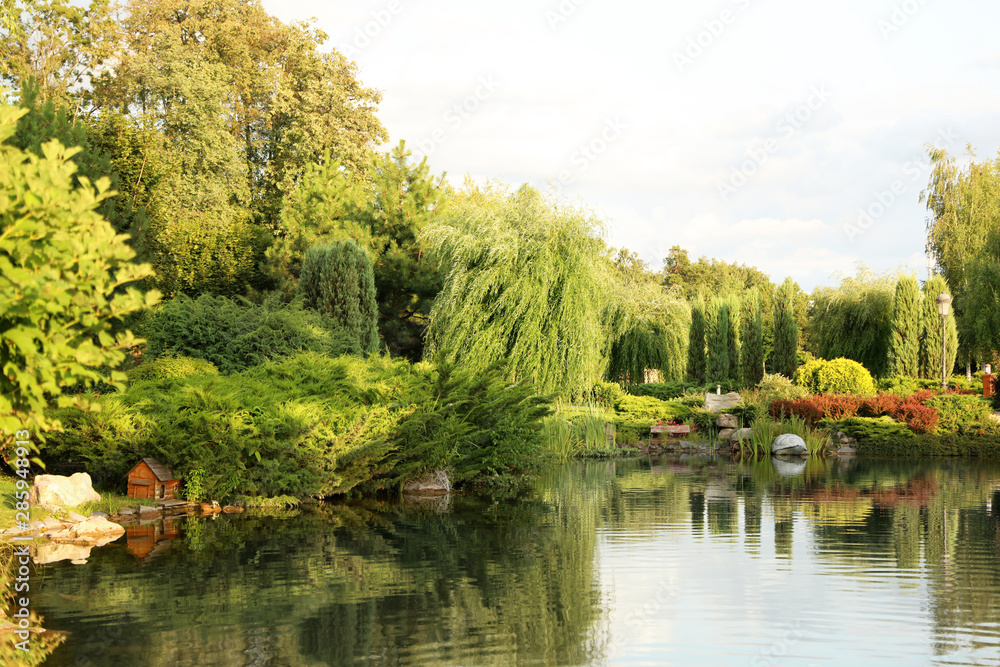 Picturesque landscape with beautiful lake on sunny day. Gardening idea Picturesque landscape with beautiful lake on sunny day. Gardening idea