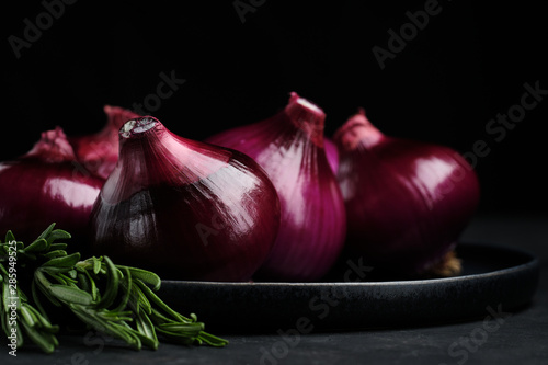 red onions on black background. food ingredients. close up