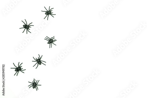 Table top view aerial image of decoration Happy Halloween day background concept.Flat lay accessories essential object to arrangement the spiders on white wooden.Copy space for creative design text.