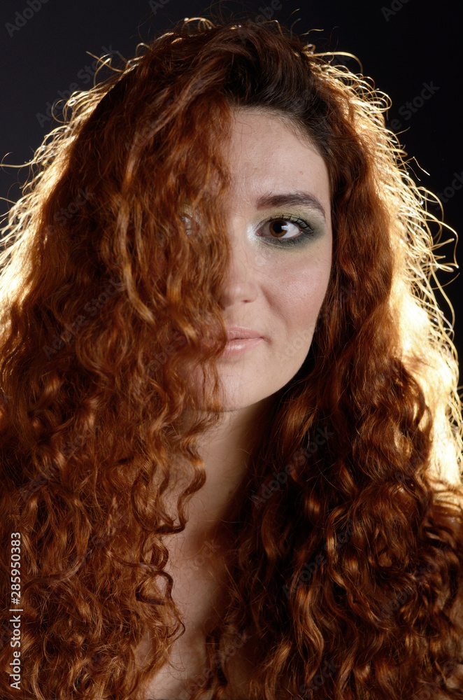 Portrait of young red haired caucasian woman with freckles