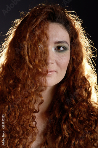Portrait of young red haired caucasian woman with freckles