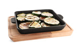 Grill pan with delicious zucchini slices on white background